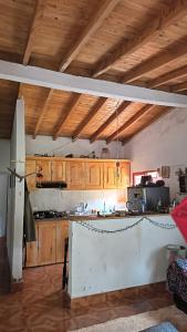 a kitchen with wooden cabinets and a kitchen island at Sendero Ancestral in Guarne