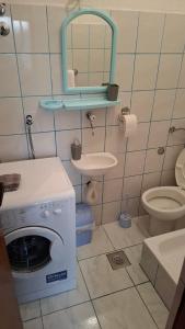 a bathroom with a washing machine and a sink at Apartman Jezero in Trebinje