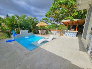 a patio with a pool and a table and chairs at Casita Almendro-Apartment With Heated Pool in San Germán