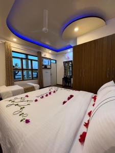 a bedroom with a bed with roses on it at Sunview Residence in Kaashidhoo +149 photos