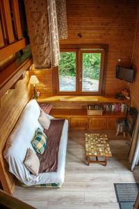 a living room in a log cabin with a chessboard at Chalet entier, vue panoramique, ruisseau et sauna. in Bussang