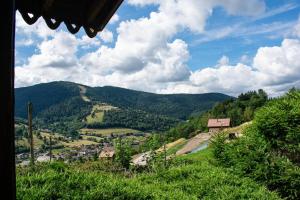 a view of a valley with mountains in the background at Chalet entier, vue panoramique, ruisseau et sauna. in Bussang