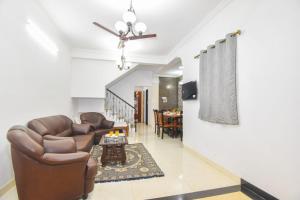 a living room with a couch and a table at Yash villa - 2 Bhk ll Private pool ll Wifi ll Tv ll in Lonavala