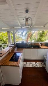 a kitchen with a counter top with a large window at Lodge Coco in Deshaies