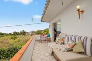 a living room with a couch on a patio at casa Jardín del sol planta alta in Tacoronte
