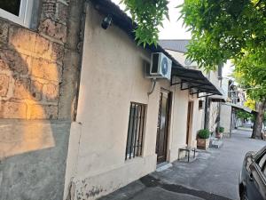 a building with a tv on the side of it at Vardan's Guest House in Yerevan