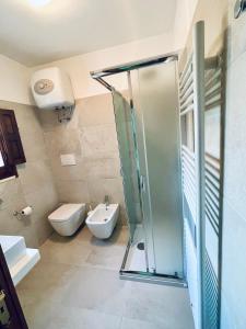 a bathroom with a glass shower and a toilet at Agriturismo Zizzi in Ceglie Messapica