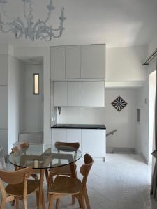 a dining room with a glass table and chairs at Marefuori Suite in Minori