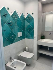 a bathroom with a toilet and a sink and a mirror at Marefuori Suite in Minori +15 photos