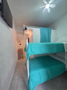a bedroom with two bunk beds and a flat screen tv at Casa Amarilla Tecámac in Santa Cruz Tecamac
