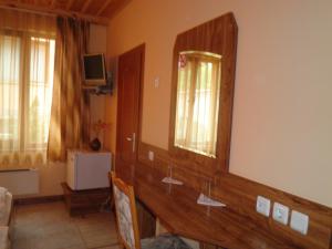 a bathroom with a large mirror on the wall at Complex Diana in Cherven