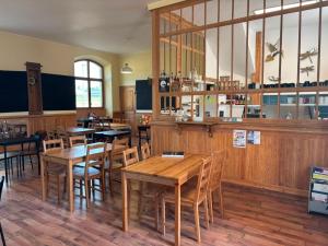 a dining room with wooden tables and chairs at L'auberge de la Ludogare in Saillagouse