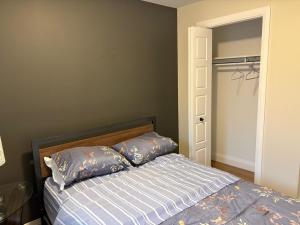 a bedroom with a bed with two pillows on it at Happy Homes in St. John's