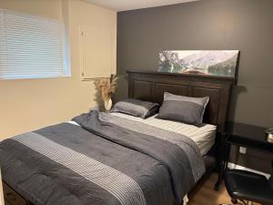 a bedroom with a bed and a window with a plant at Happy Homes in St. John's