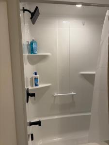 a bathroom with a shower with a glass shower backdoor at Happy Homes in St. John's