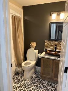 a bathroom with a toilet and a sink at Happy Homes in St. John's