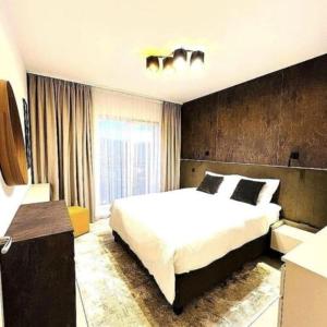 a bedroom with a large bed and a window at Tomorrowland Residence in Boom