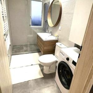 a small bathroom with a washing machine in it at Tomorrowland Residence in Boom