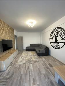 a living room with a couch and a flat screen tv at Tomorrowland Residence in Boom