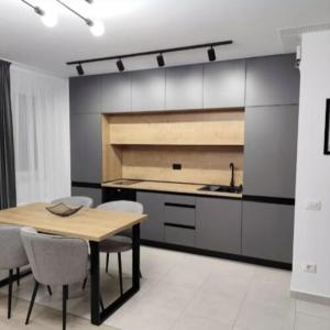 a kitchen with a table and chairs and a sink at Tomorrowland Residence in Boom