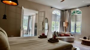 a bedroom with a large bed and a couch at Coconuts Tropical Boutique Hotel Curaçao in Willemstad +109 photos