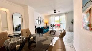 a living room with a glass table and a couch at Carihuela Playa Los Nidos 1 in Torremolinos