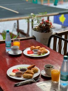 a table with two plates of food and drinks on it at Gio Camping Shala River in Mollʼ e Shoshit