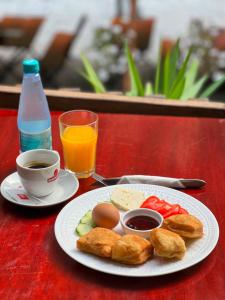 a plate of food with eggs and bread and a cup of coffee at Gio Camping Shala River in Mollʼ e Shoshit +12 photos