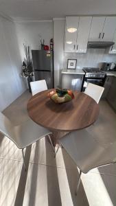 a kitchen with a wooden table and chairs in a kitchen at Family Friendly One Bedroom Studio in Brisbane