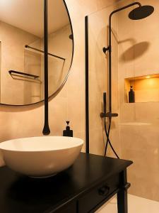 a bathroom with a white sink and a mirror at Casa Centro in Hervás +38 photos