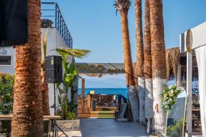 a view of the ocean from a hotel with palm trees at Ondo Beach & Suites in Bodrum City