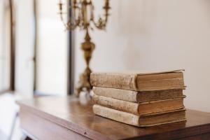 a stack of old books sitting on a table at B&B Palazzo Agrippa in Bominaco