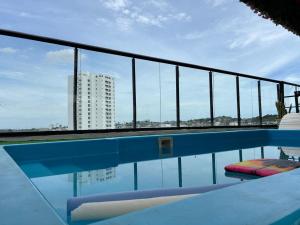 a swimming pool with a view of a building at Hostel HA LUXURY in Cartagena de Indias