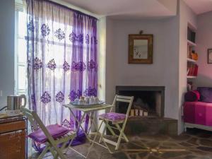 a living room with a table and chairs and a fireplace at St. Thomas Bed and Breakfast in Paianía