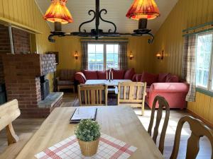 a living room with a table and a couch at Torsetlia Cottages and Apartments in Uvdal