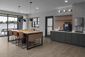 a kitchen with a table and some chairs in it at StudioRes by Marriott Clearfield Layton in Clearfield