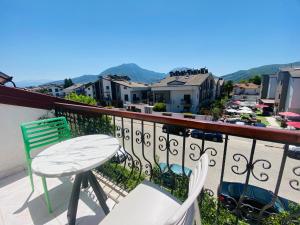 a balcony with a table and chairs and a city at Ceres26 in Fethiye