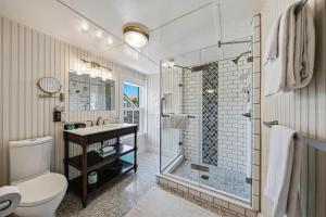 a bathroom with a shower and a toilet and a sink at Carlisle House Inn in Nantucket +189 photos