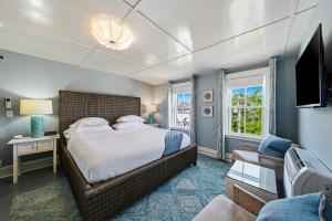 a bedroom with a bed and a living room at Carlisle House Inn in Nantucket