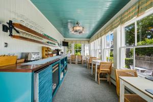 a restaurant with blue counters and tables and windows at Carlisle House Inn in Nantucket