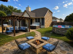 a backyard with a fire pit and chairs and a grill at Spacious 4BR Retreat |Pool Table| Firepit & Hottub in Kyle