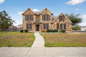 a large stone house with a driveway at Spacious 4BR Retreat |Pool Table| Firepit & Hottub in Kyle
