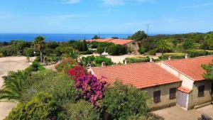 an aerial view of a house with flowers and trees at Locations proche de la plage de Barcaggio accessible par une piste en terre de 3,5 kilometres de Tizzano en voiture in Sartène