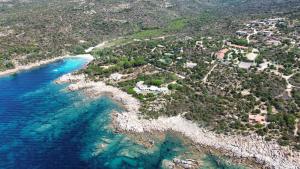 an aerial view of a beach and the ocean at Locations proche de la plage de Barcaggio accessible par une piste en terre de 3,5 kilometres de Tizzano en voiture in Sartène