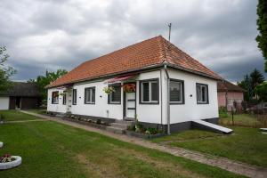 a small white house with a red roof at Klára House - Covasna in Covasna