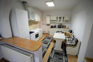 a kitchen with a refrigerator and a table in it at Klára House - Covasna in Covasna