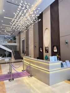 a lobby with a reception desk and a staircase at فندق بارك برايم - Park Prime Hotel in Mecca