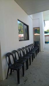 a row of black chairs lined up against a wall at Next House Passi City in Iprog +6 photos