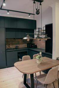 a kitchen with a wooden table and some chairs at Appartement Promenadenhirsch in Bad Gastein