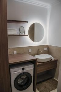 a bathroom with a washing machine and a sink at Appartement Promenadenhirsch in Bad Gastein +12 photos